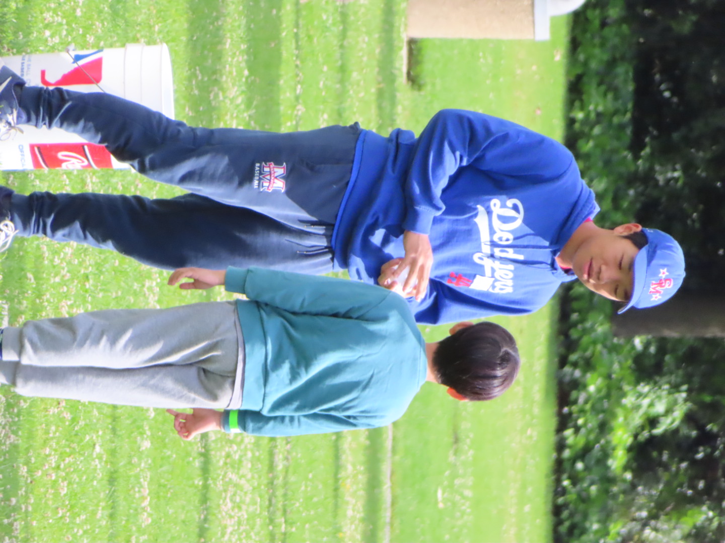 Vincent coaching a young player on the field